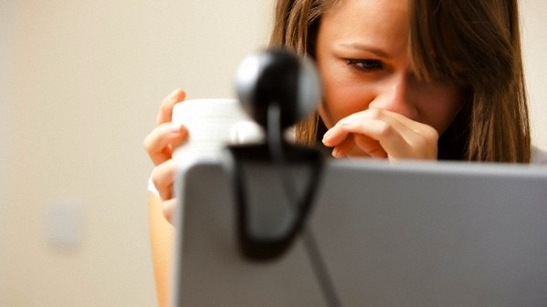 UK --- Close up of a woman using laptop computer with web cam --- Image by Â© Julian Winslow/ableimages/Corbis