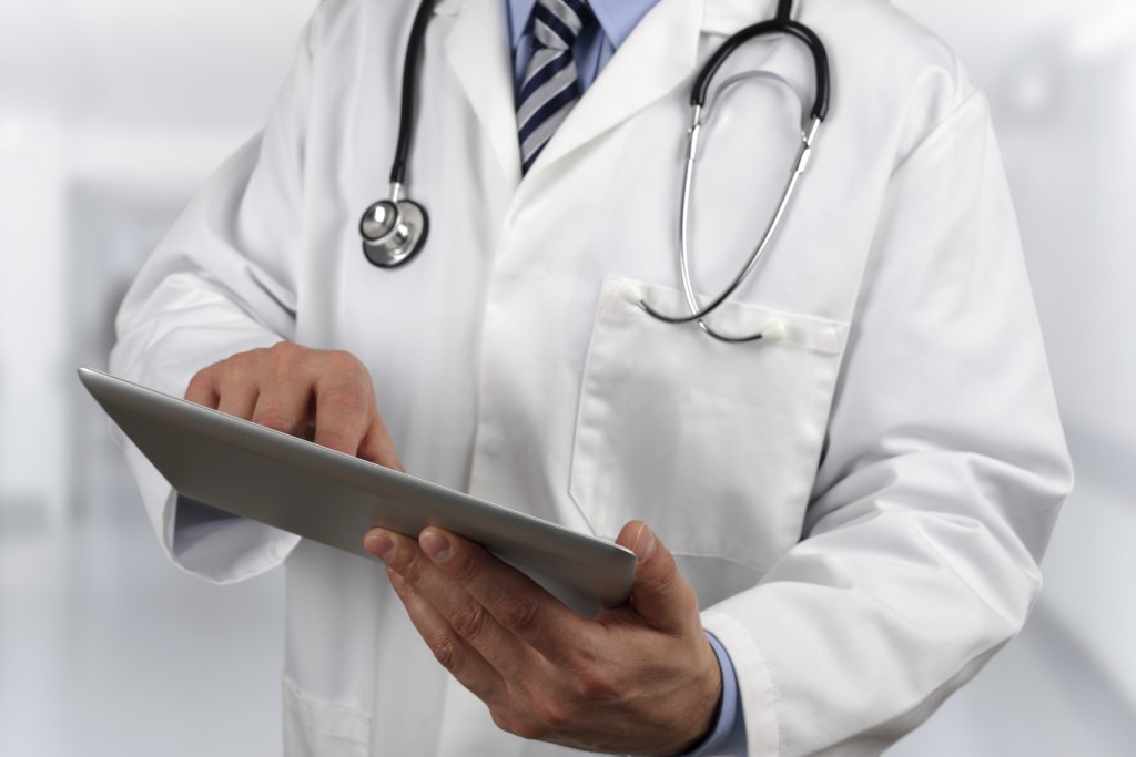 Doctor using digital tablet