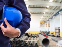 Worker in front of a production site