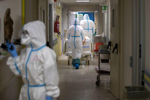 A member of medical staff wearing a personal protective equipment (PPE) walks in the Intensive Care Unit (ICU) for the novel coronavirus, COVID-19 cases, in the San Filippo Neri hospital in Rome, on October 30, 2020. - Italy's Prime Minister Giuseppe Conte tightened nationwide coronavirus restrictions after the country registered a record number of new cases, despite opposition from regional heads and street protests over curfews. ANSA/MASSIMO PERCOSSI