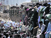 epa09430527 Afghans struggle to reach the foreign forces to show their credentials to flee the country outside the Hamid Karzai International Airport, in Kabul, Afghanistan, 26 August 2021. At least 13 people including children were killed in a blast outside the airport on 26 August. The blast occurred outside the Abbey Gate and follows recent security warnings of attacks ahead of the 31 August deadline for US troops withdrawal.  EPA/AKHTER GULFAM