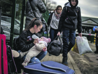 epaselect epa09783747 A woman feeds a child as people fleeing Ukraine arrive in Slovakia through the Ubla border crossing, 25 February 2022. Slovakia said it will let fleeing Ukrainians into the country following Russia's military operation in Ukraine. The Slovak Police Force announced on social media that people not holding a valid travel document will also be eligible for entry on an individual basis.  EPA/MARTIN DIVISEK