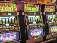 In this June 23, 2021 photo, a row of slot machines sit empty at Bally's casino in Atlantic City N.J. A gambling technology company and a virtual mental health clinic announced Wednesday, July 7, 2021, that they are joining with New Jersey's Rutgers University to study the effectiveness of compulsive gambling and video game-playing treatments that are offered in a virtual setting. (AP Photo/Wayne Parry)
